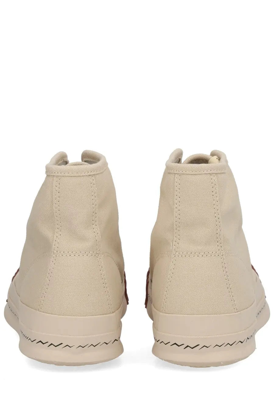 Beige visvim men’s skagway hi sneaker with high-top canvas upper and black zigzag stitching along the sole