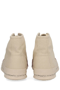 Beige visvim men’s skagway hi sneaker with high-top canvas upper and black zigzag stitching along the sole
