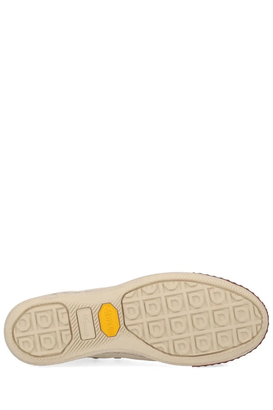 Beige rubber sole with yellow vibram logo and textured tread pattern on visvim men’s skagway hi sneaker white