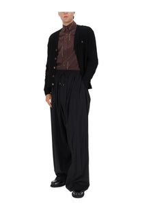 Vivienne westwood men’s cardigan alex black paired with black wide-leg trousers with a drawstring waist