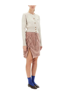 A soft pink velvet skirt with ruched front and side slit paired with vivienne westwood womens cardigan bea white