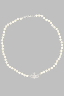 A delicate white pearl necklace with a silver vivienne westwood orb pendant in basso rilievo silver
