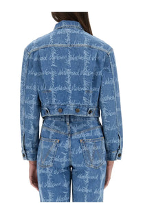 Back of vivienne westwood women’s cropped blue denim jacket with repeating white westwood script print on back and sleeves