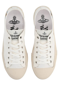 Vivienne Westwood women’s low top plimsoll sneaker white canvas with beige rubber soles and silver eyelets visible logo insole