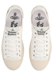 Vivienne Westwood women’s low top plimsoll sneaker in white canvas with beige soles and silver eyelets featuring logo insole