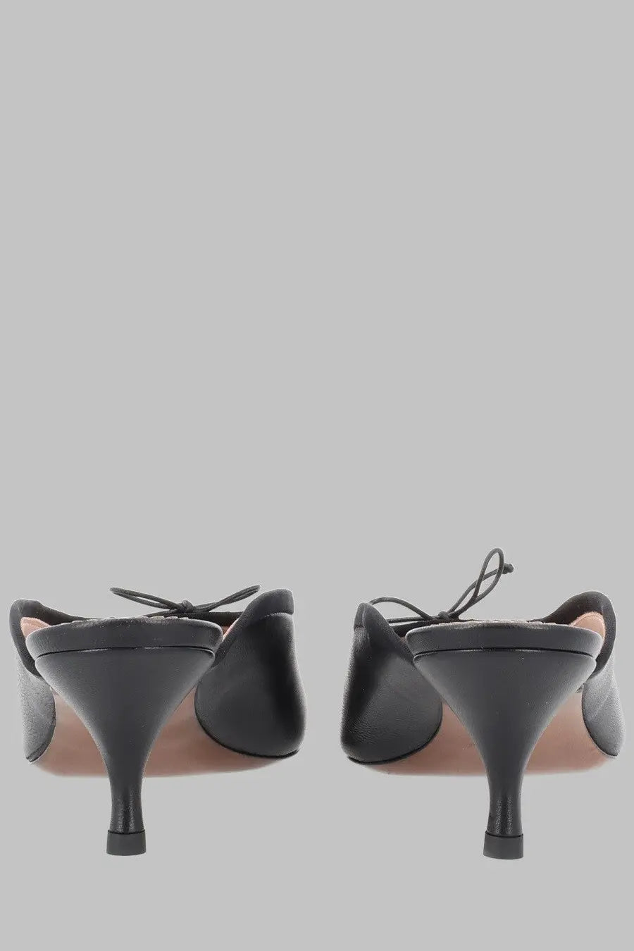 Vivienne Westwood women’s black leather mules with bow detail at the back and slender heel shown from the back side