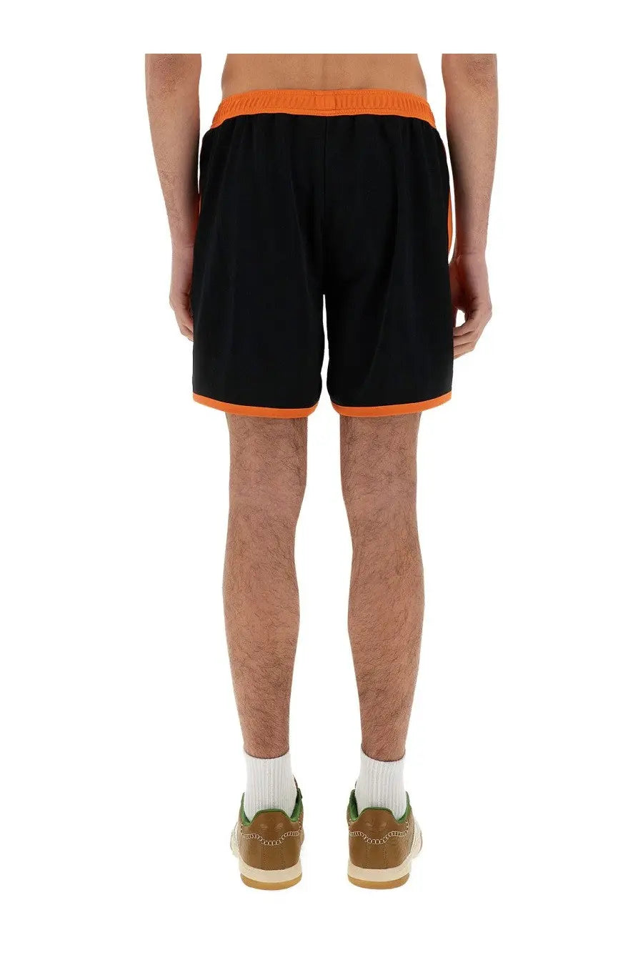 Wales Bonner men’s black jersey shorts with bright orange elastic waistband and matching trim for athletic wear