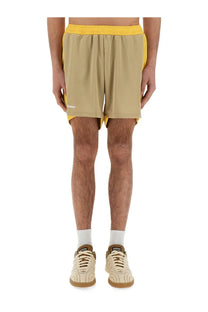 Wales Bonner men’s jersey shorts in beige and yellow with elastic waistband and bomber logo on the left leg