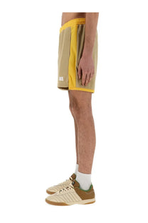 Wales Bonner men’s yellow jersey shorts with beige side stripe elastic waistband and white logo on left leg