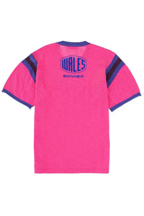 Bright pink wales bonner unisex short-sleeved shirt with navy blue collar, cuffs, shoulders trim, and logo detailing