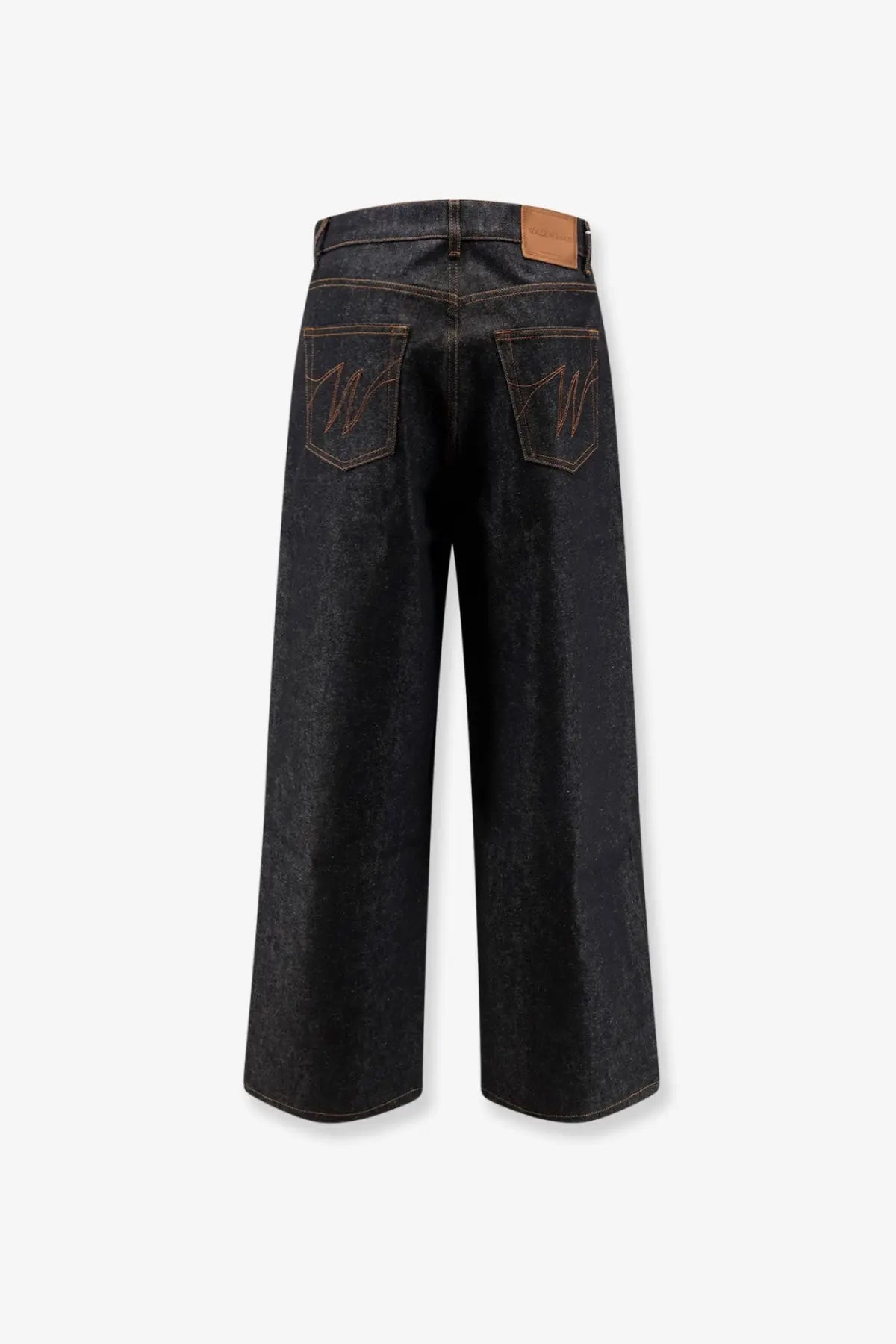 Back side of walk in Paris men’s baggy blue denim jeans in dark indigo with embroidered w logos and leather patch