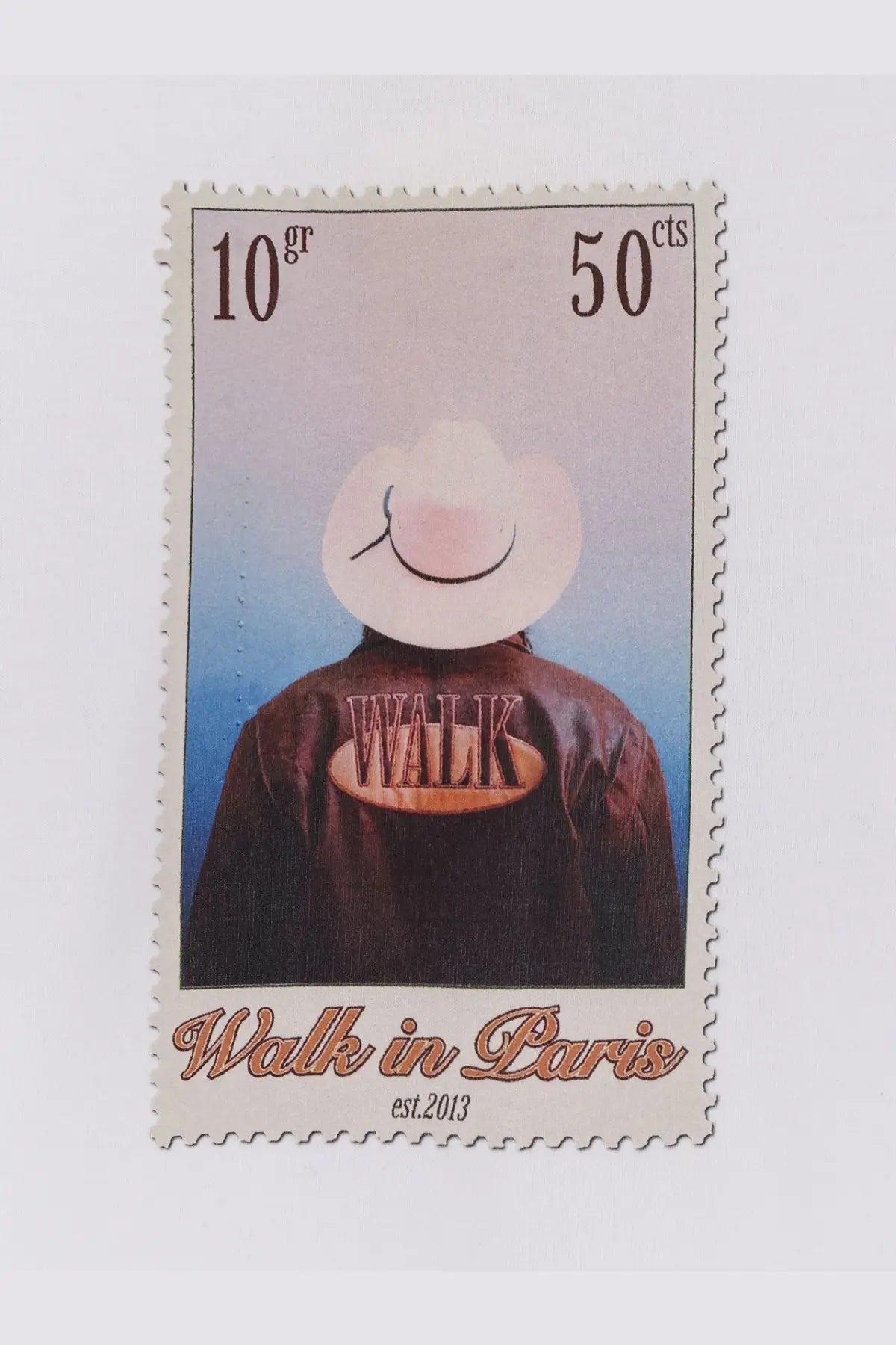 Beige and brown postage stamp featuring a person in a white cowboy hat and dark leather jacket with walk embroidery