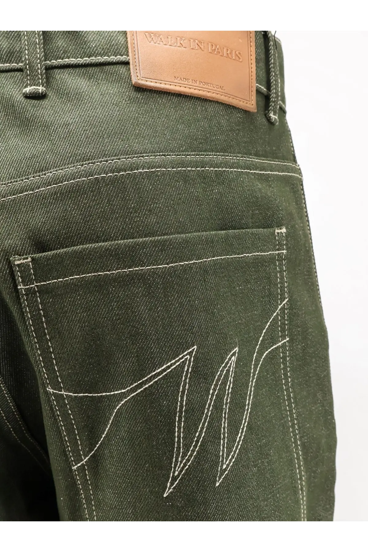 Backside of walk in paris men’s double knee green denim trousers in dark olive green with white stitched logo and brown leather patch