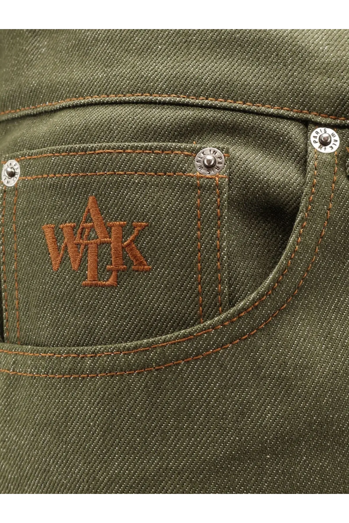 Olive green denim jeans pocket with brown embroidered wak logo and silver rivets on walk in paris gardeners trousers back