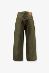 Olive green wide-leg denim trousers with a brown leather brand patch at the waistband walk in paris mens gardeners denim