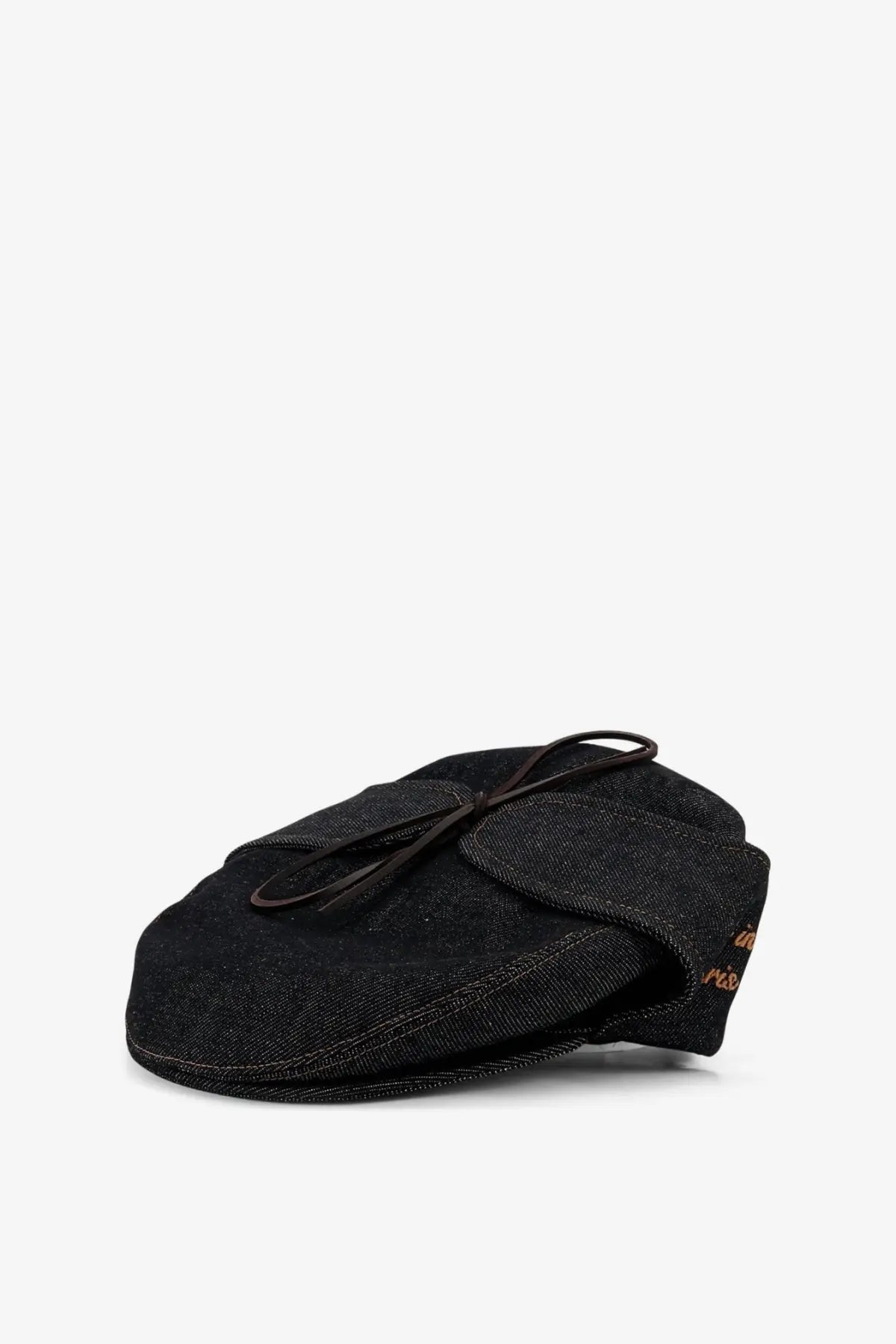 Black denim flat cap with tied leather bow and subtle gold embroidery on the side from walk in paris mens sherlock raw denim hat blue