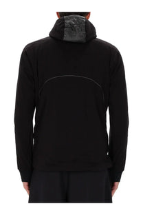 Back side of and wander men’s alpha air jacket black with subtle white stitch and dark gray textured neckline panel