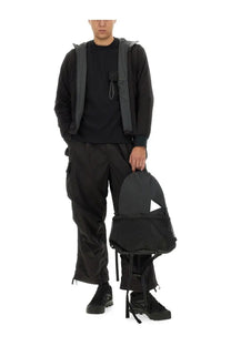 Black mesh and fabric backpack with triangular cutout detail shown from back in and wander men’s alpha air sweatshirt black