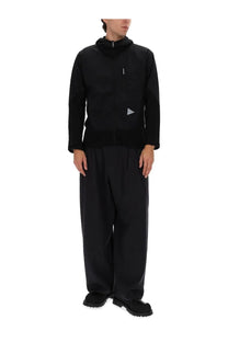 And wander men’s alpha direct jacket black with hood and subtle silver triangular logo on the chest