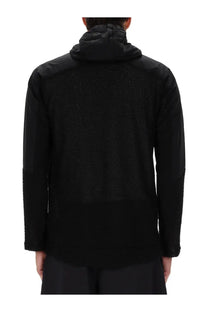 And wander men’s alpha direct jacket black back side showing textured mesh panel with solid fabric sleeves