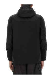 And wander men’s hooded jacket in black with sleek modern design and subtle paneling details viewed from the back