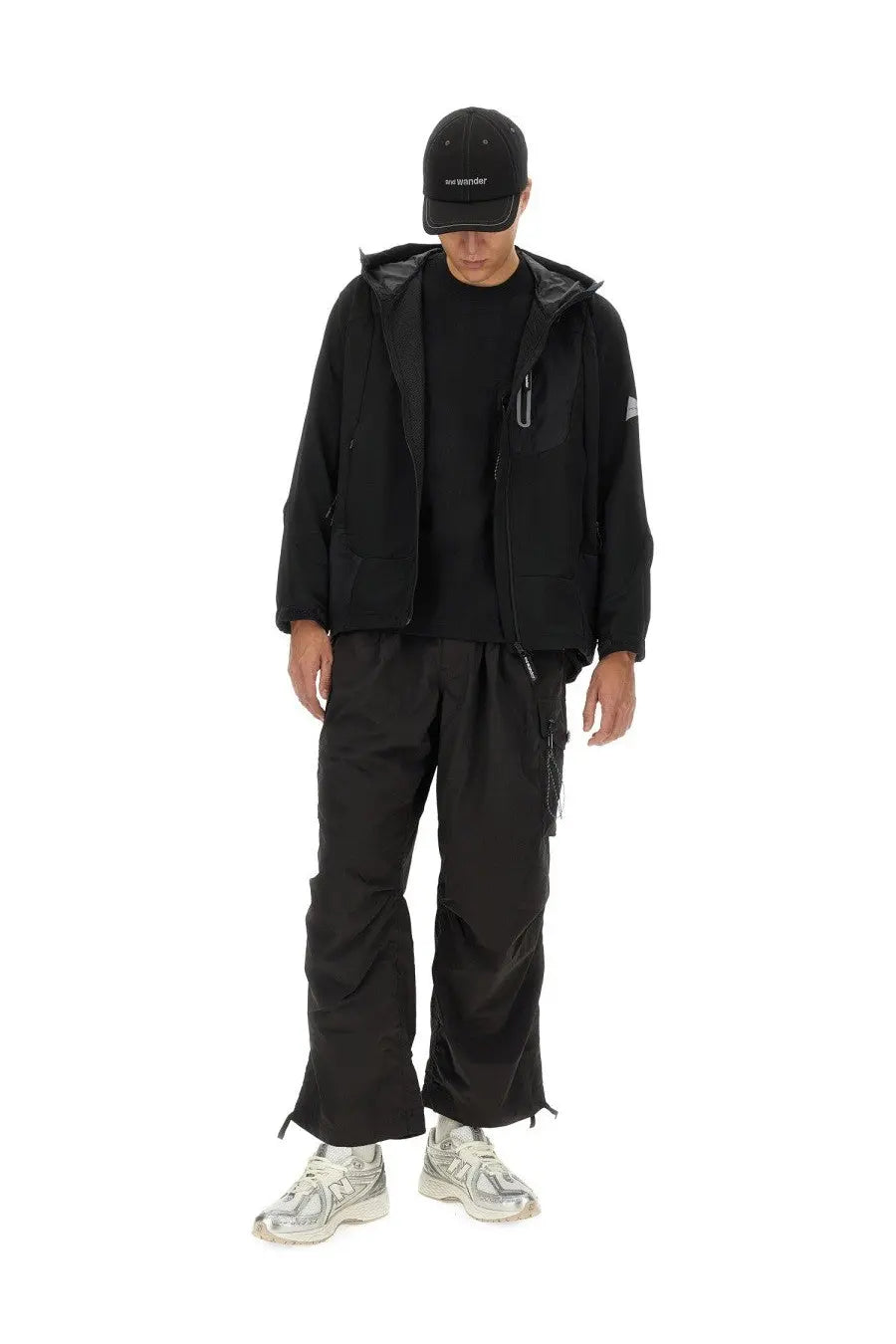 And wander men’s black hooded jacket with subtle silver zipper accents and small white logo on sleeve