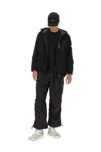 And wander men’s black hooded jacket with subtle silver zipper accents and small white logo on sleeve