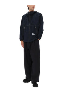 Men’s navy blue hooded jacket with subtle white stitching and triangular logo patch made with partex fabric