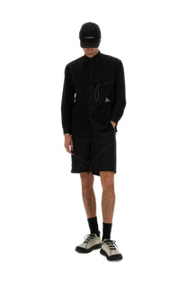 Men’s black long-sleeved button-up shirt with subtle geometric stitching and nylon shorts for versatile wear