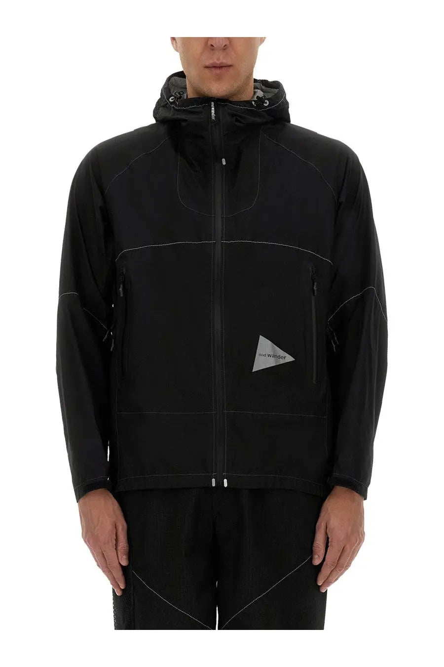 And wander men’s ul jacket black with subtle white stitching and reflective triangular logo on the chest