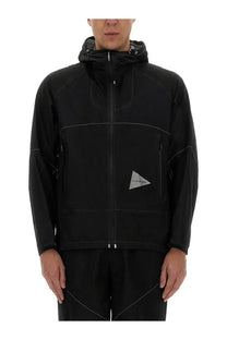 And wander men’s ul jacket black with subtle white stitching and reflective triangular logo on the chest