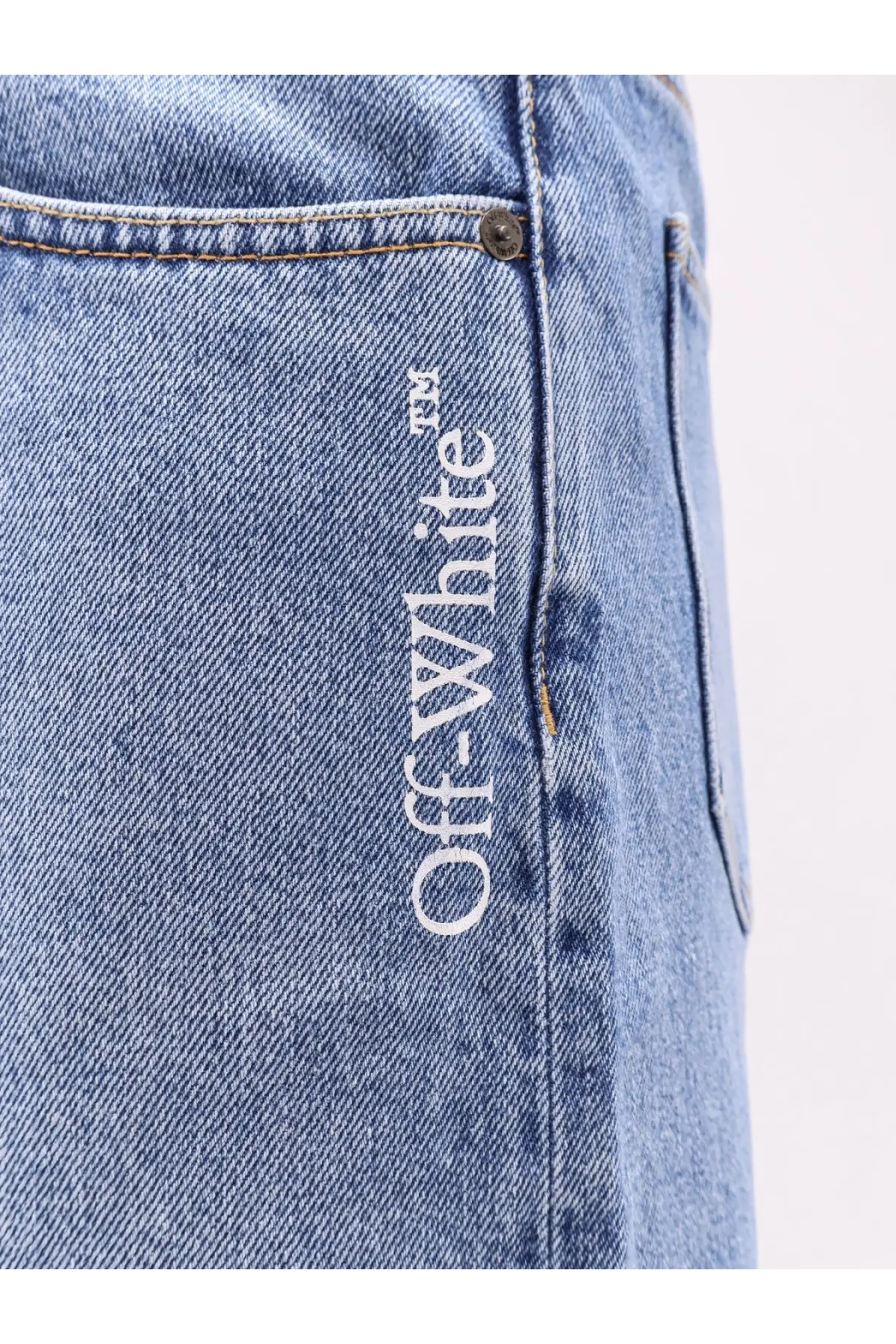 Off-White men’s light-wash denim shorts with white off-white logo embroidered vertically along the seam