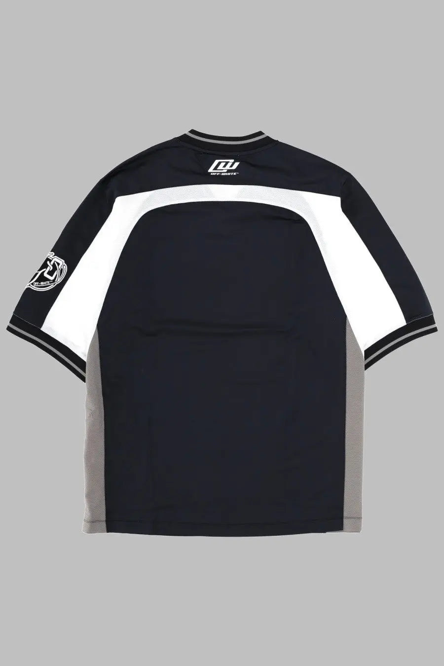 Back view of off-white men’s black short-sleeved eagle team soccer t-shirt with white gray panels and logo on collar and sleeve