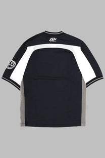 Back view of off-white men’s black short-sleeved eagle team soccer t-shirt with white gray panels and logo on collar and sleeve