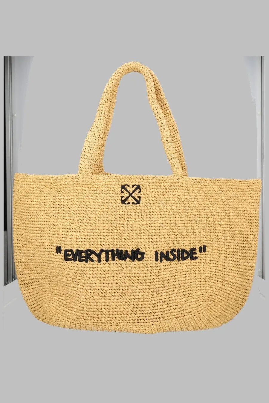 Yellow woven straw tote bag with black embroidered off-white logo and phrase everything inside on front panel