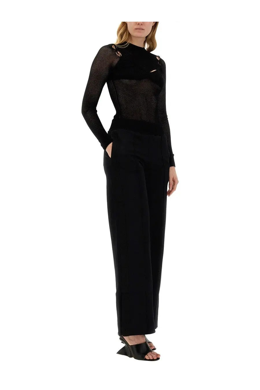 Off-white women’s wide leg pants black paired with a black long-sleeved mesh top with sheer textured fabric and shoulder embellishments