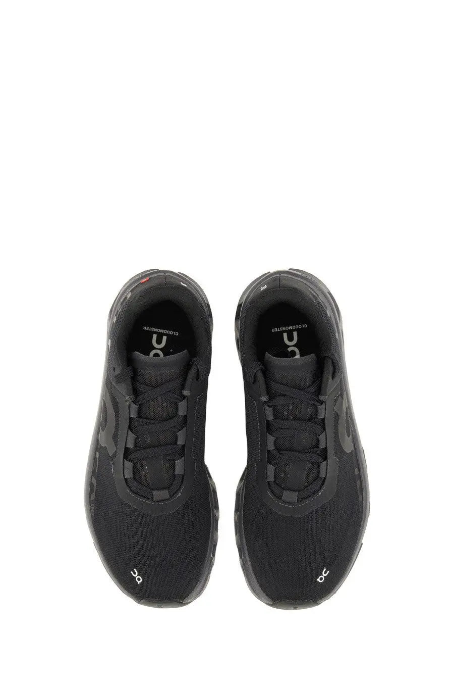 On women’s cloudmonster sneaker black with mesh upper and rubber sole designed for running and comfort