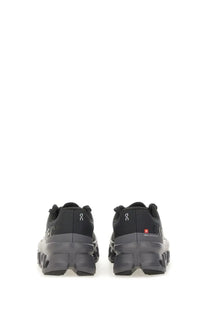 On women’s Cloudmonster sneaker black trail running shoes with rugged chunky sole and subtle branding details