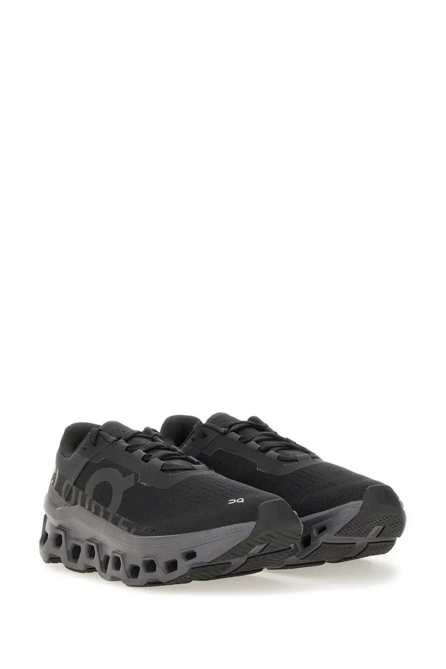 On women’s cloudmonster sneaker black with chunky sole design and subtle gray accents on the midsole