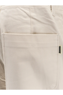Beige cotton canvas pocket with brand tag on woodbird men’s denim trousers white back side