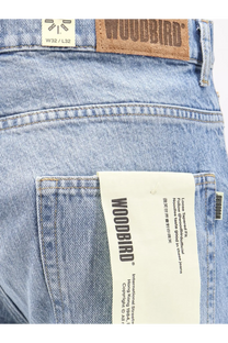 Woodbird men’s leroy denim jeans in light-wash blue with brown leather patch and white paper logo tag