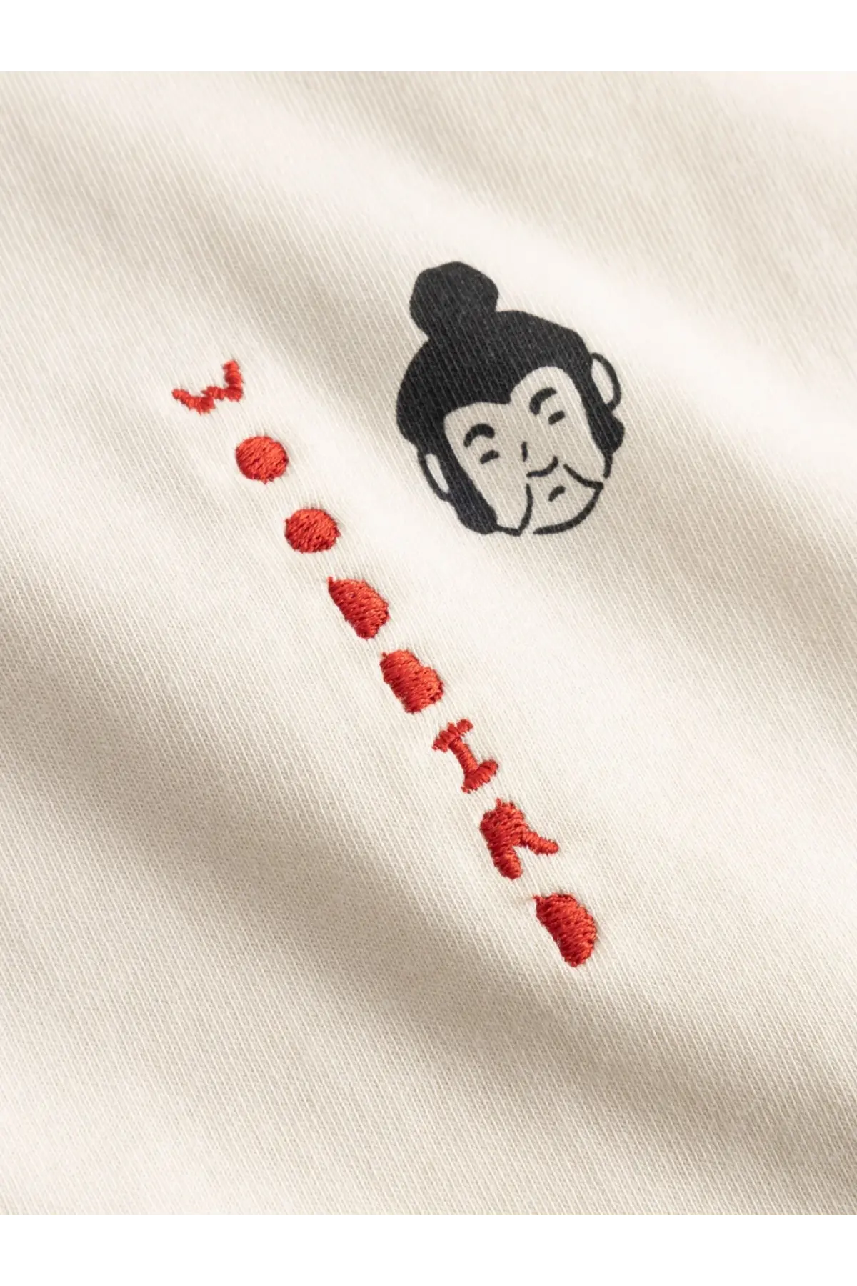Woodbird mens cream cotton t-shirt with black embroidered buddha head and red stitched lettering in white color