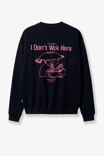 Black crewneck sweatshirt with pink line-art eating noodles graphic and i dont wok here text on the back woodbird mens organic cotton sweater blue