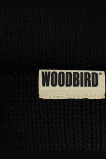 Black knitted woodbird beanie hat with white woven label made of wool and acrylic for men