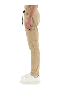 Woolrich men’s beige cargo pants made of durable fabric with drawstring waist and multiple functional pockets