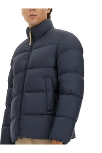Dark blue quilted woolrich men’s down jacket with high collar and zipper closure in cloud blue color