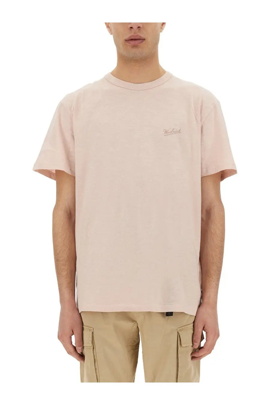 A soft blush pink short-sleeved crew neck t-shirt with subtle embroidery suitable for casual wear