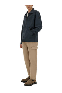 Woolrich men’s dark navy waterproof jacket with subtle logo patch on left sleeve designed for outdoor use