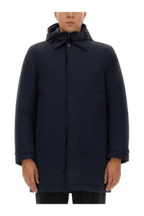 Woolrich men’s navy blue nylon jacket with a dark hooded coat featuring a structured collar and subtle stitching details