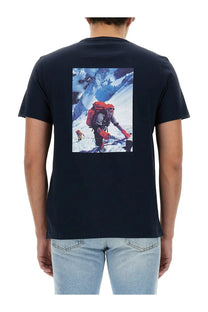 Woolrich men’s navy blue cotton t-shirt with vibrant climber graphic on snow-covered mountain terrain